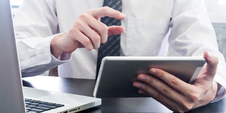 Concept photo of a businessman using his tablet to access a virtual court hearing and observe the proceedings.