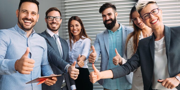 Photo of a diverse and smiling legal team who have managed to rebuild a positive corporate culture after COVID.