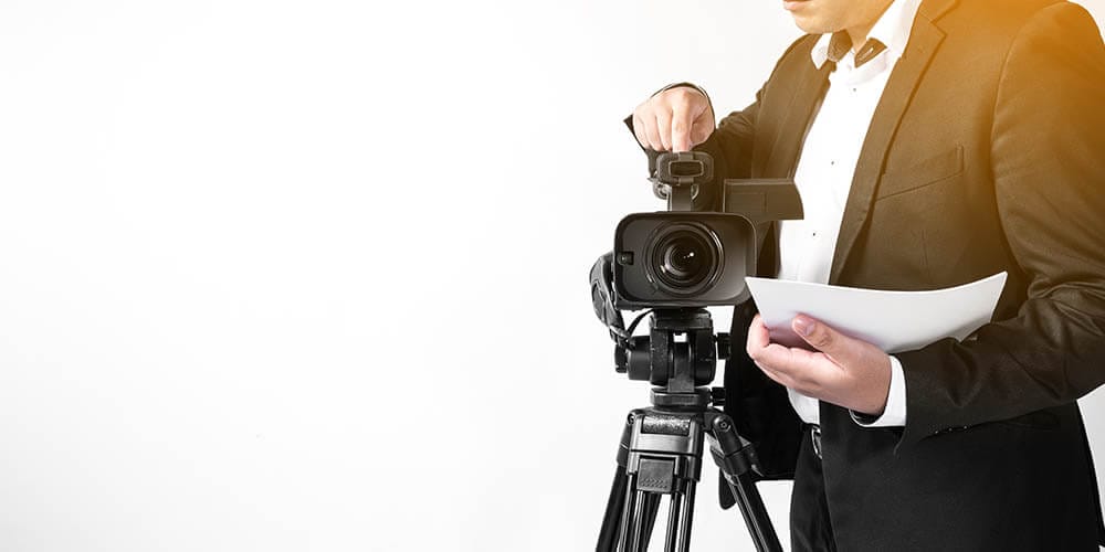 Legal Videographer Setting Up His Camera For A Deposition Meeting