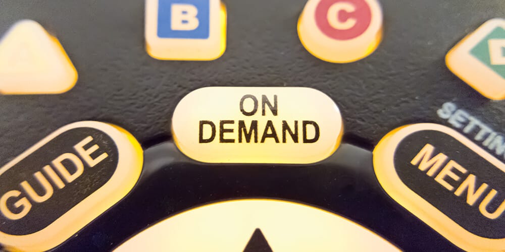 Photo of the ‘On Demand’ button of a television remote, which illustrates the ease and convenience of on-demand legal services.