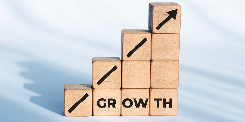 Concept photo of a staircase of wooden blocks with the word ‘growth’ written on the side - illustrating the professional growth of a court reporter.
